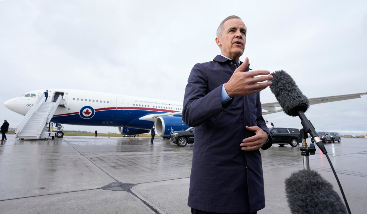 Canada Prime Minister Mark Carney speaks with members of the media before he boards a government pl...