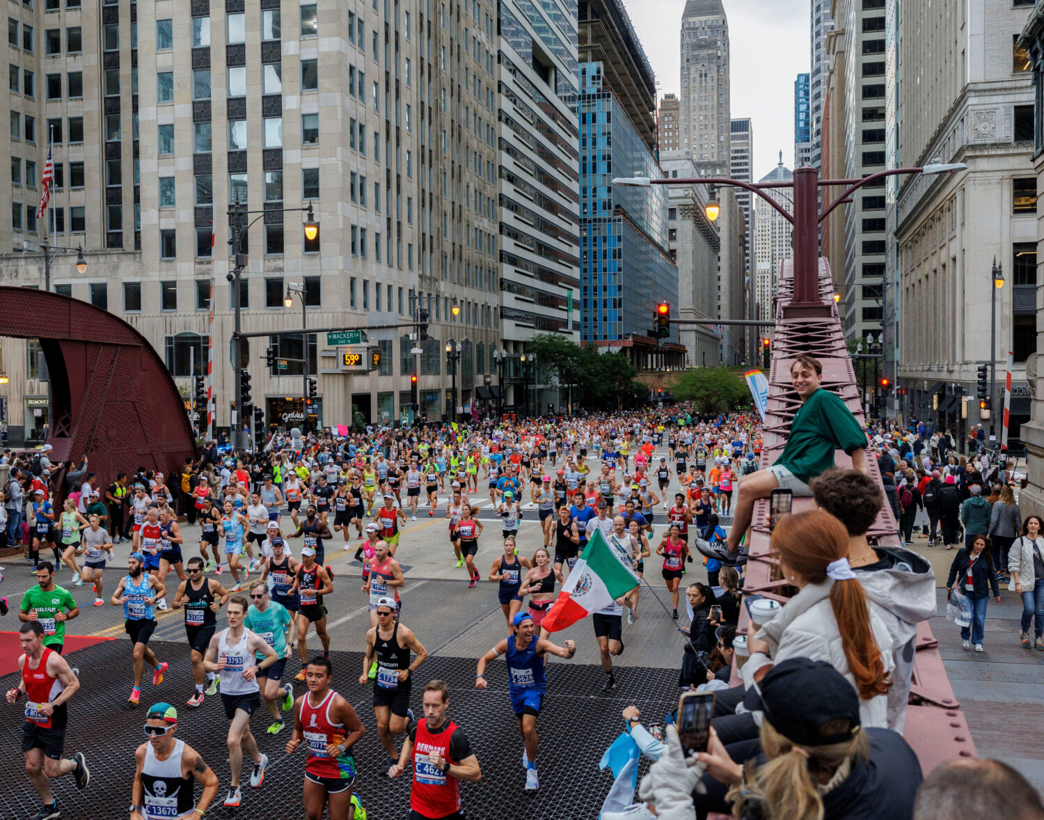 FILE - Runners cross the LaSalle Street bridge during the Chicago Marathon, Sunday, Oct. 13, 2024, ...