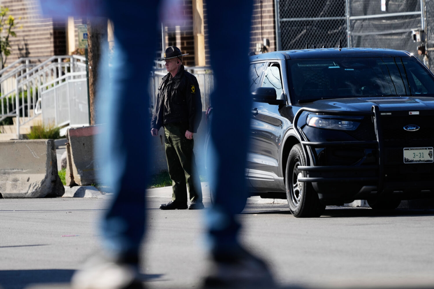 A Illinois State Police officer stands outside an ICE (U.S. Immigration and Customs Enforcement) pr...