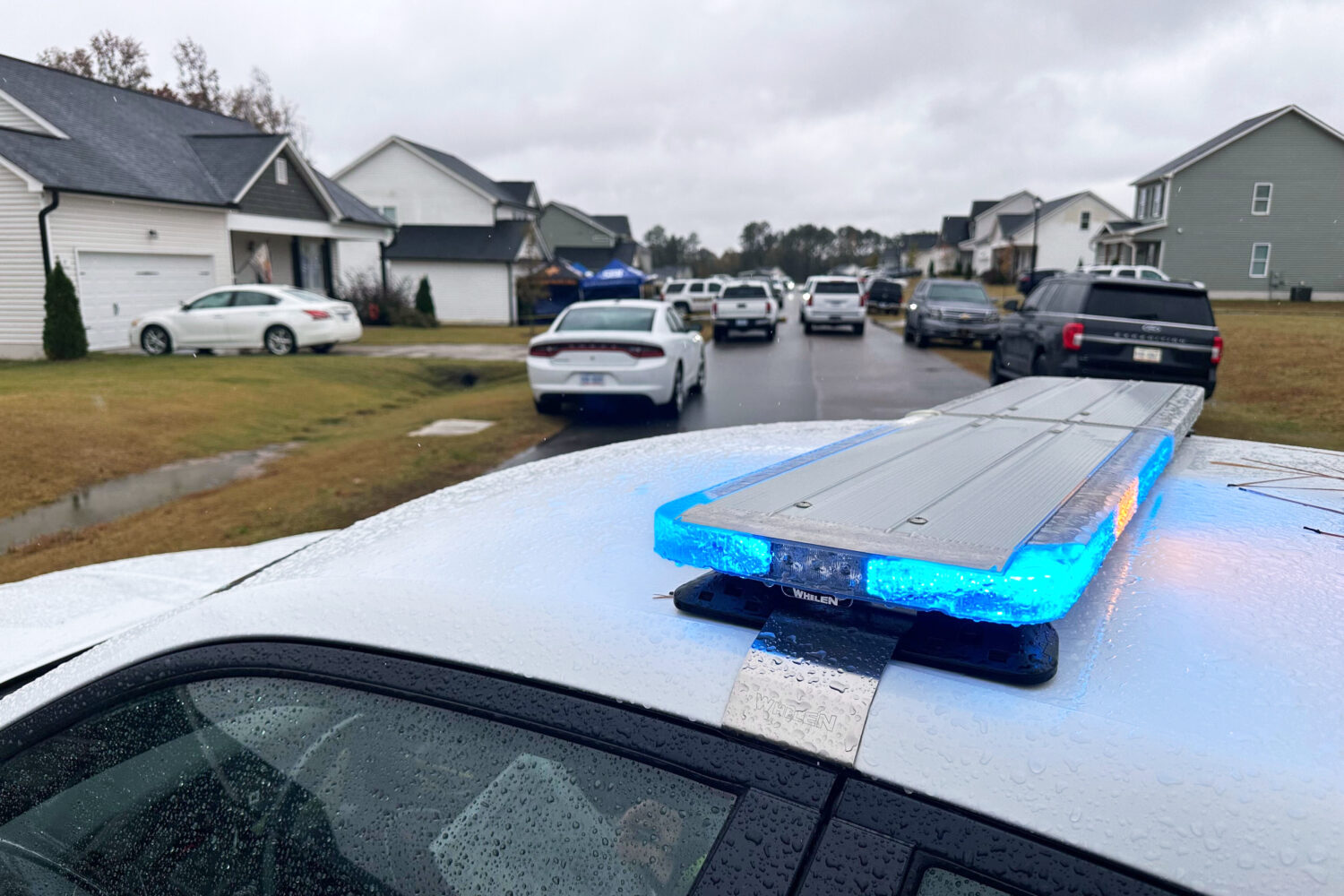 Law enforcement vehicles block the road to Wellington Delano Dickens III's home, where remains were...