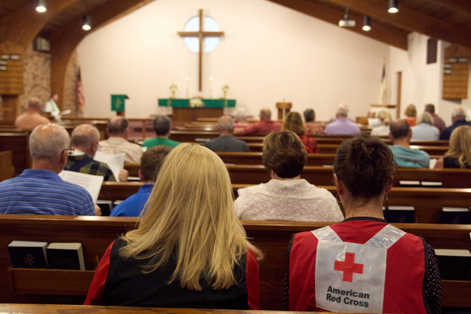 A woman wearing an American Red Cross shirt is seen during a service for the Sunday morning shootin...