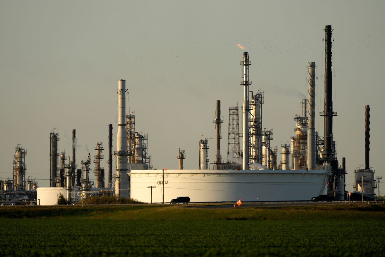 FILE - A motorist drives past the CHS oil refinery Sept. 28, 2024, in McPherson, Kan. (AP Photo/Cha...