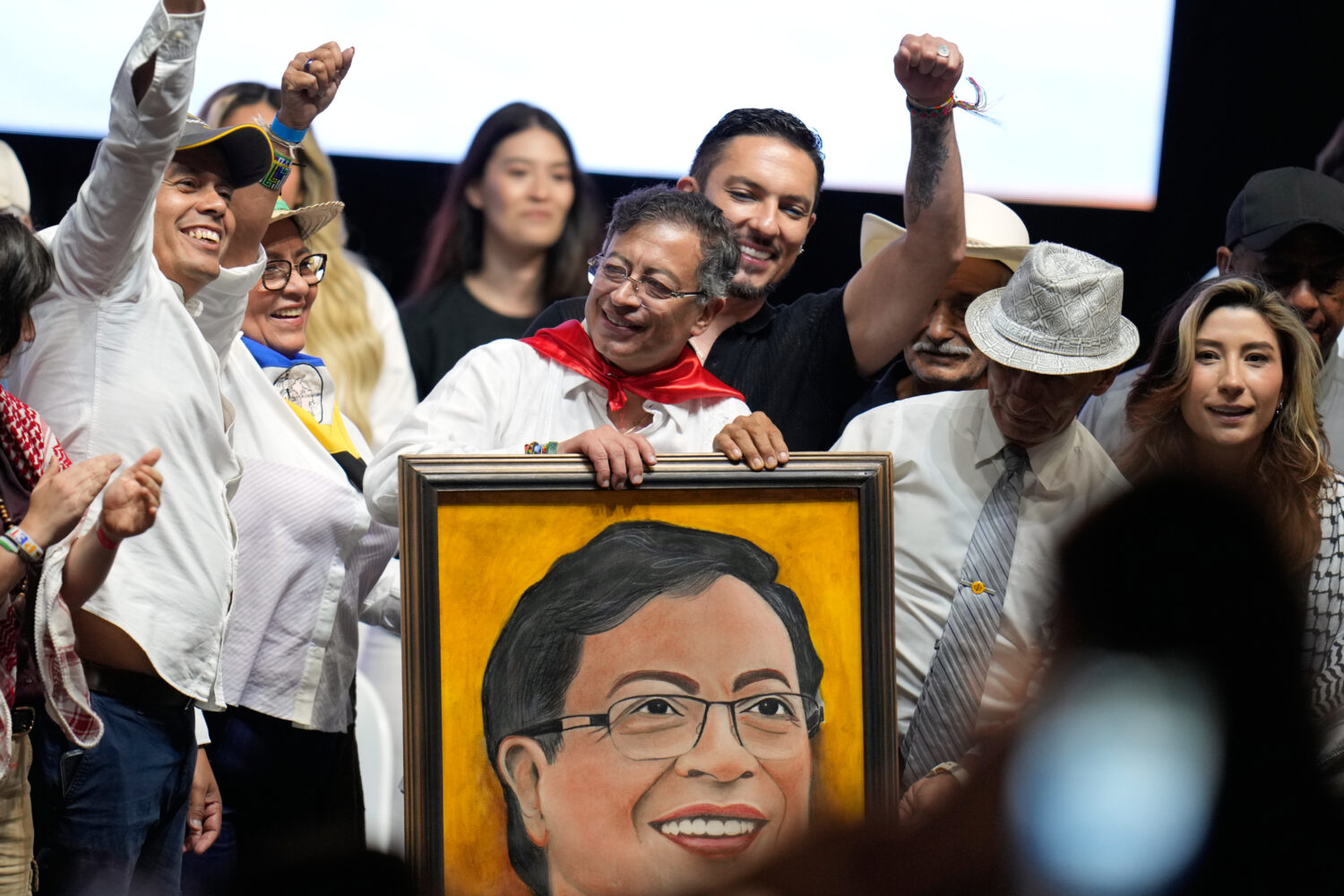 Colombian President Gustavo Petro holds up a portrait given to him by a supporter during a rally in...