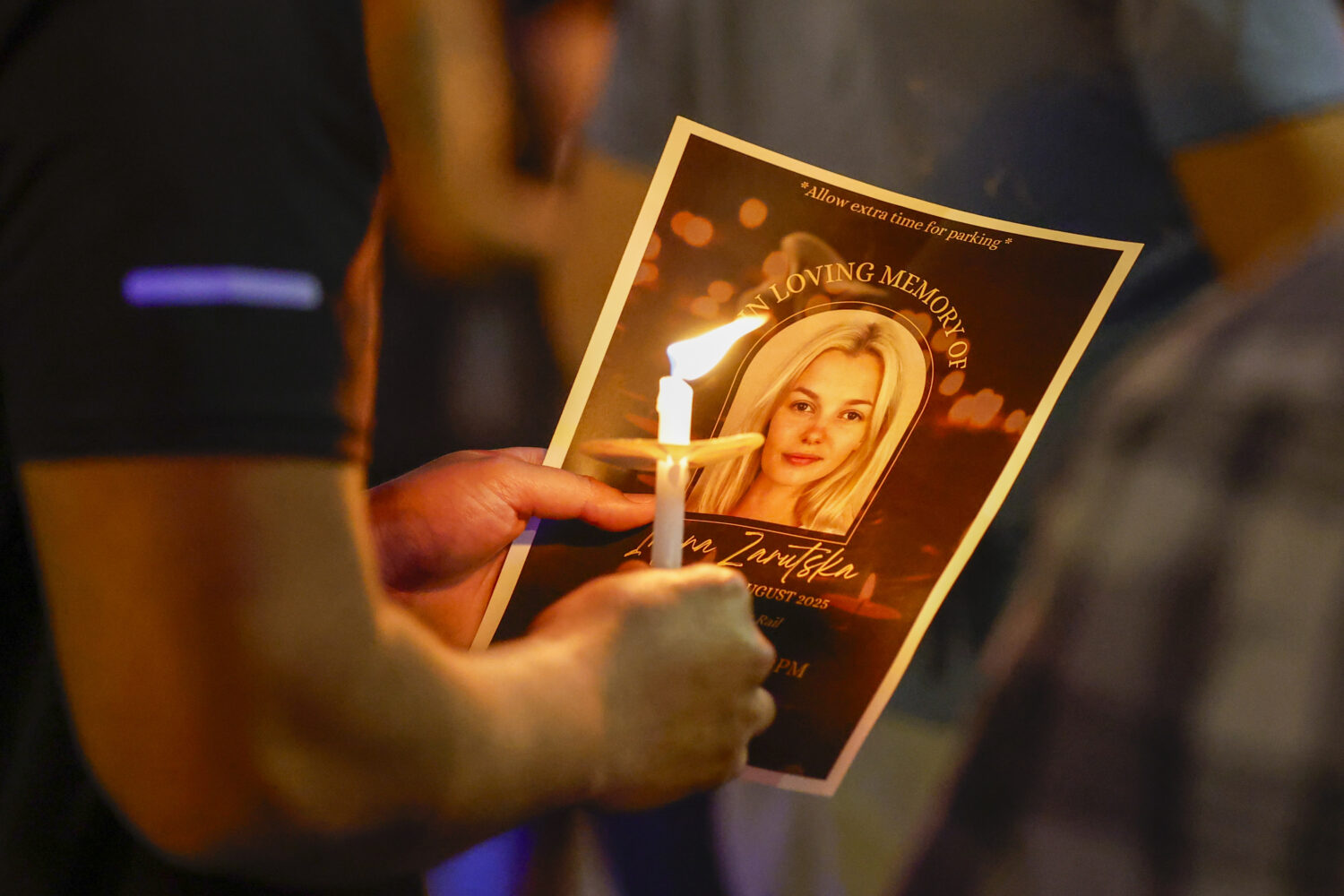 Community members gather for a vigil honoring the life of Iryna Zarutska, who was fatally stabbed o...