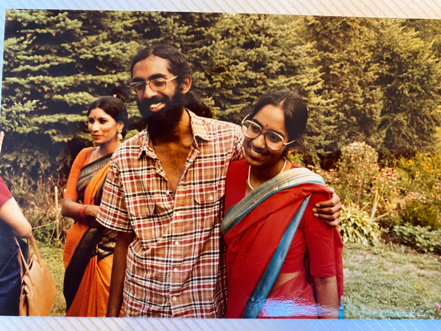 Tejaswini Rao chats with party guests while Subramanyam and Saraswathi Vedam embrace during their p...
