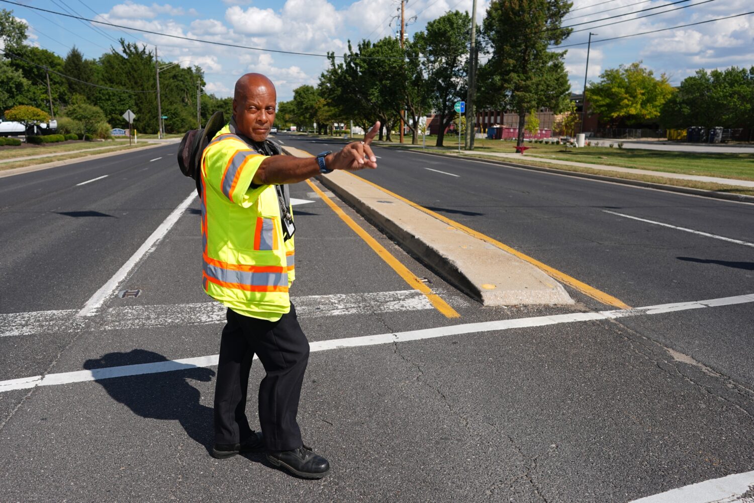 School crossing guard Anthony Taylor directs students on when to cross the street, Wednesday, Sept....