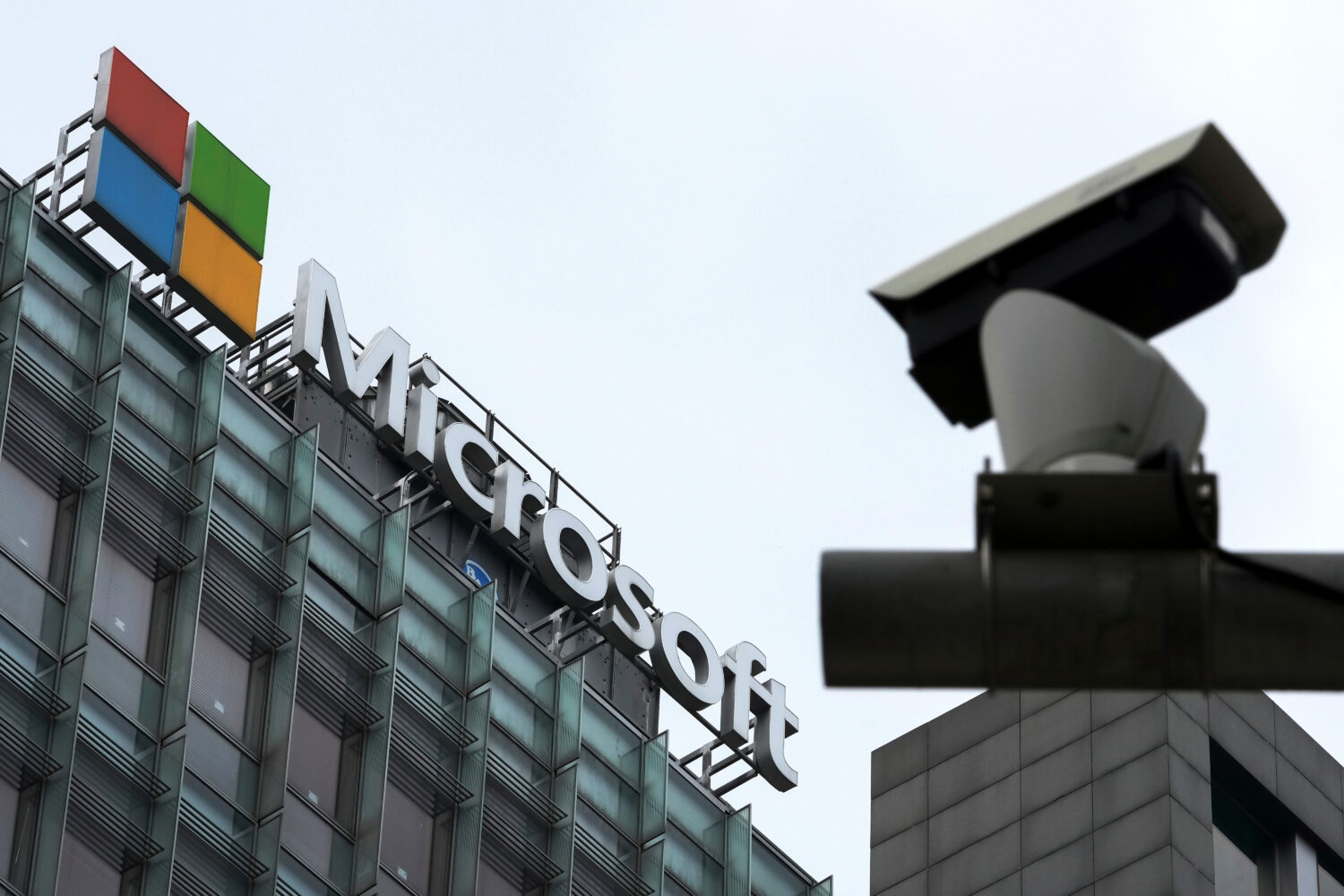 FILE - A security surveillance camera is seen near the Microsoft office building in Beijing, July 2...