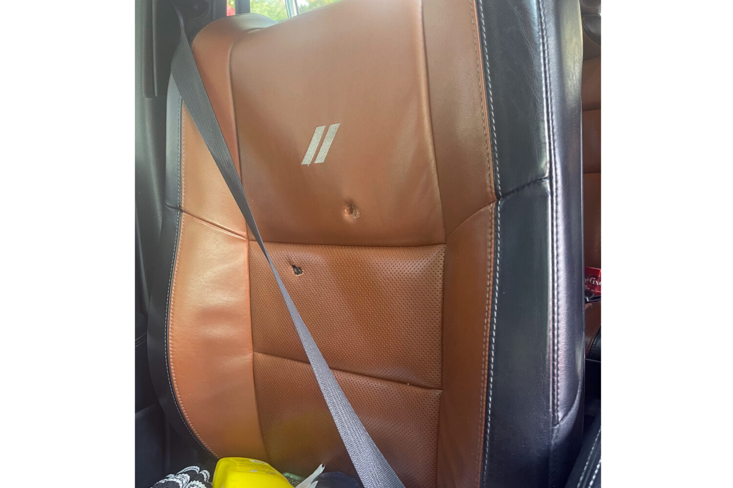 This image provided by Elizabeth Paige White shows bullet holes in a seat in a vehicle of Phillip M...