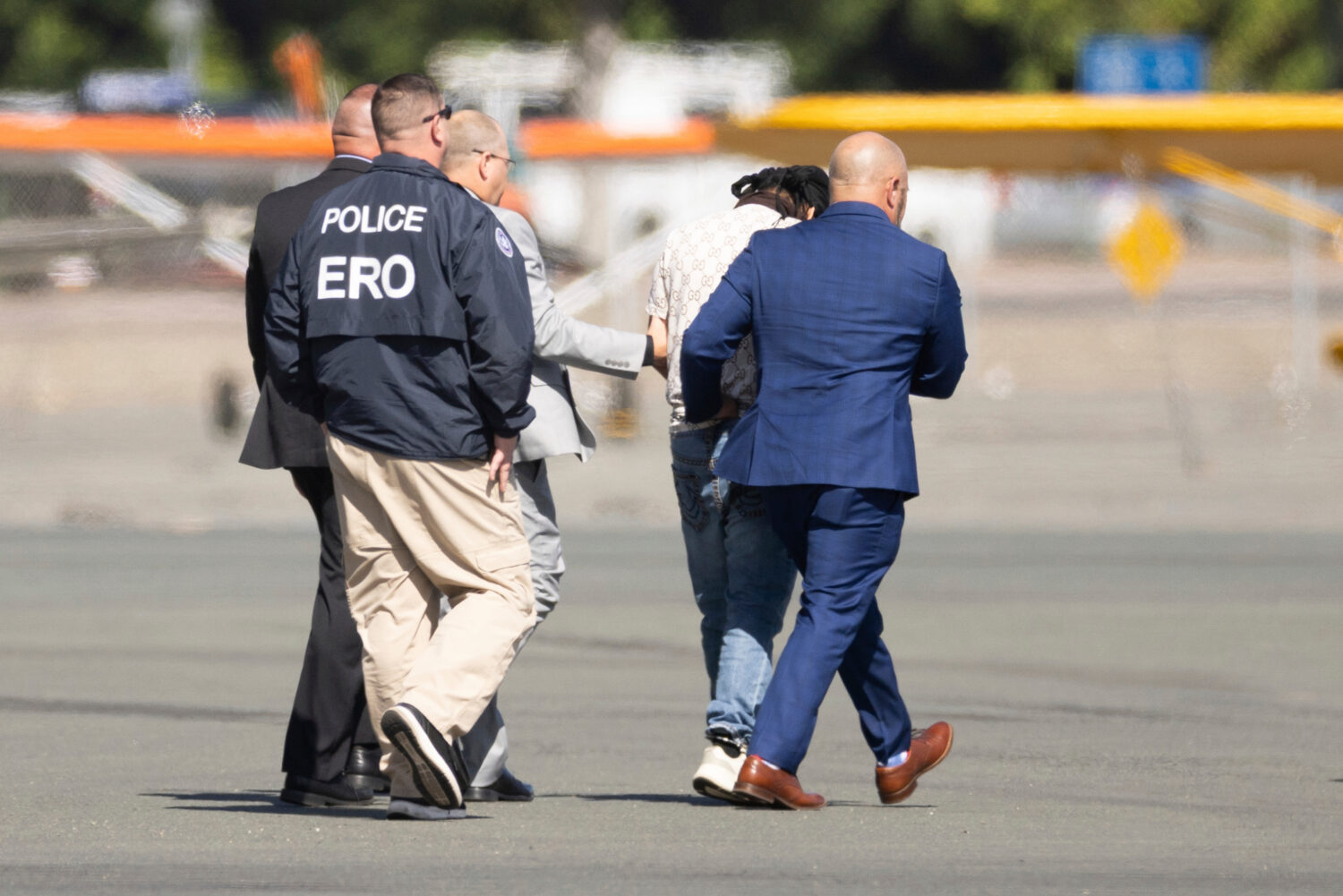 FILE - Harjinder Singh is escorted to an airplane by Florida Lt. Gov. Jay Collins and law enforceme...