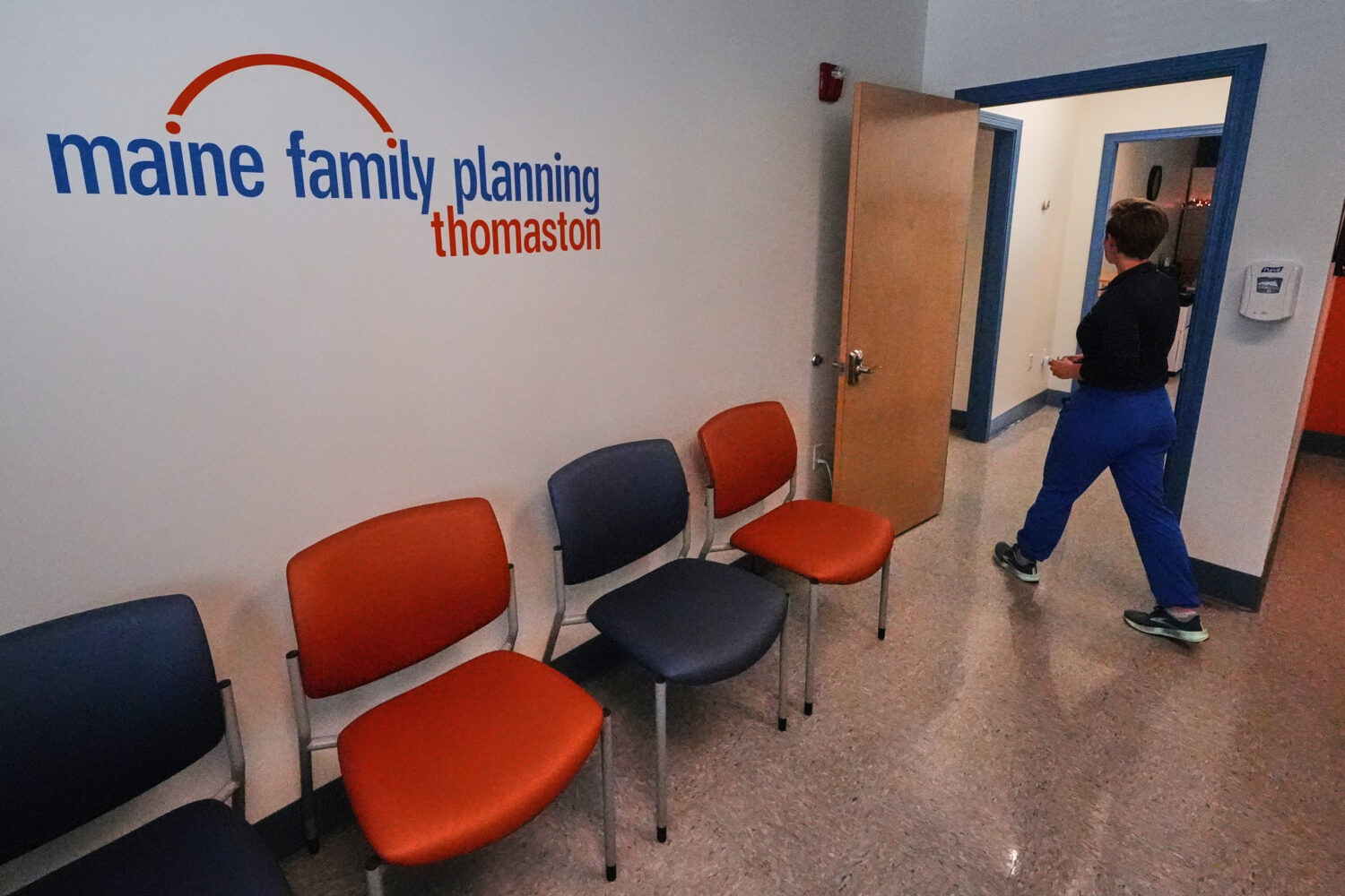 FILE - Vanessa Shields-Haas, a nurse practitioner, walks from the lobby toward the examination room...