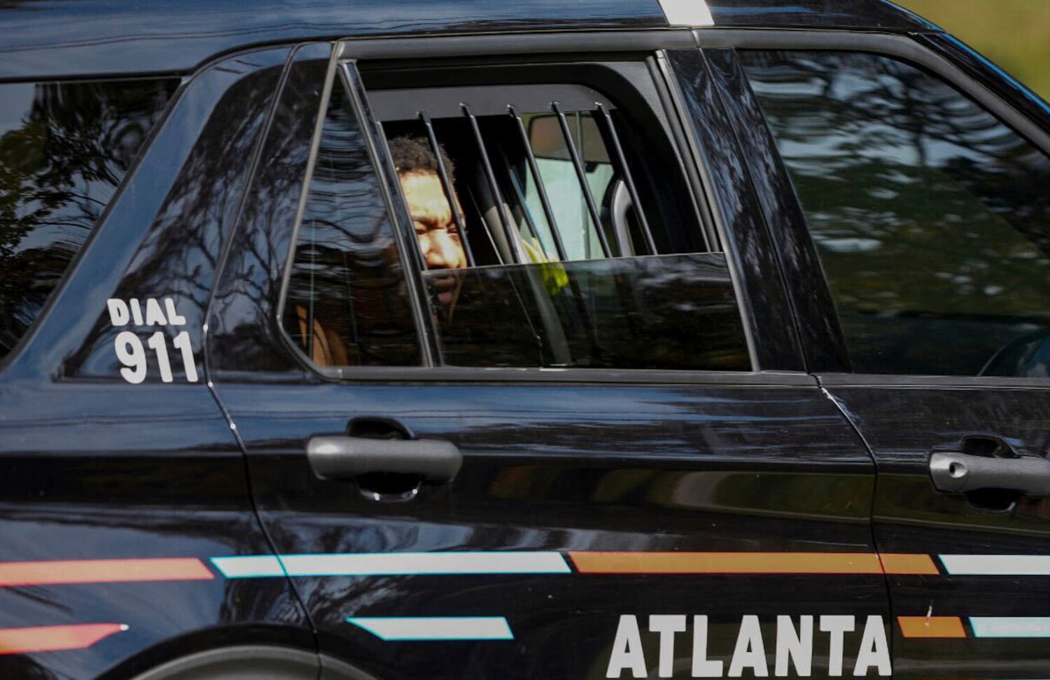 FILE - Derrick Groves sits in a police vehicle after being taken into custody by U.S. Marshals and ...