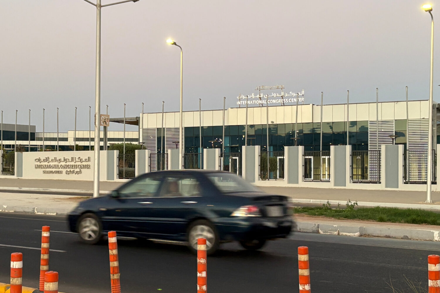 A vehicle passes in front of the International Conference Center where Israeli and Hamas officials ...