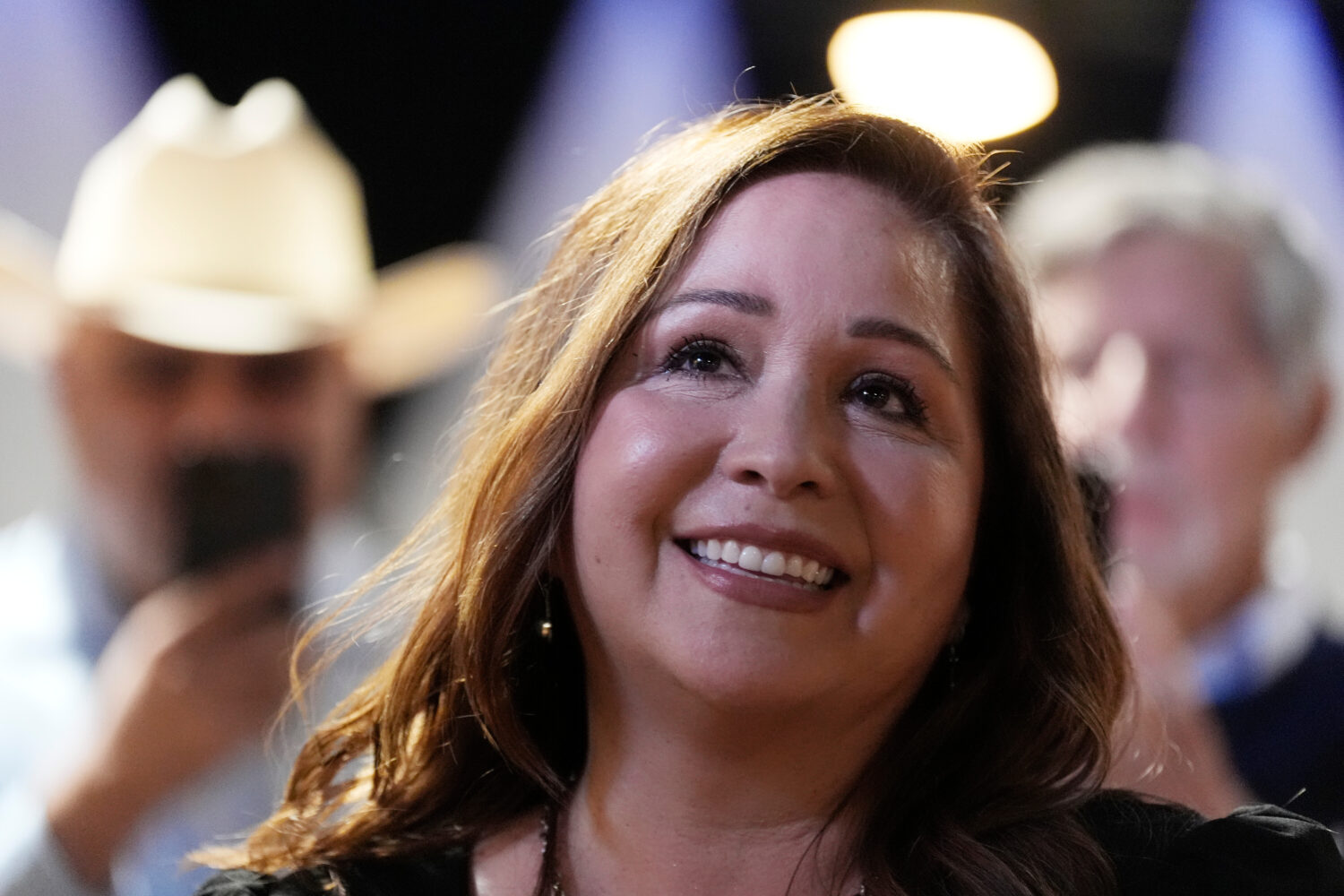 Arizona Democratic candidate Adelita Grijalva listens to her children speak at the stage podium aft...