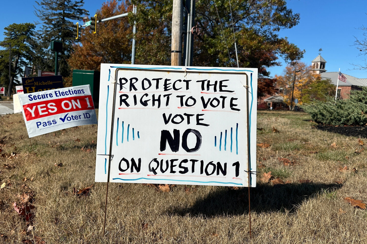 Signs supporting and opposing a voter identification referendum in the state are shown Thursday, Oc...