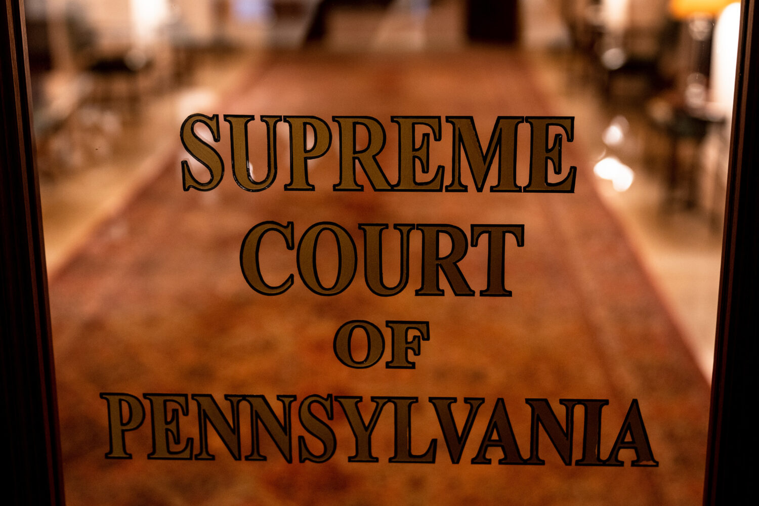 FILE - A sign on a door at The Supreme Court of Pennsylvania is pictured at the Capitol in Harrisbu...