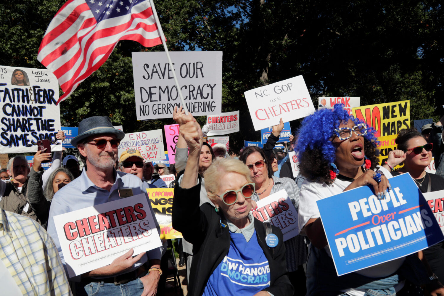 Attendees cheer during a rally protesting a proposed redistricting map Tuesday, Oct. 21, 2025, in R...