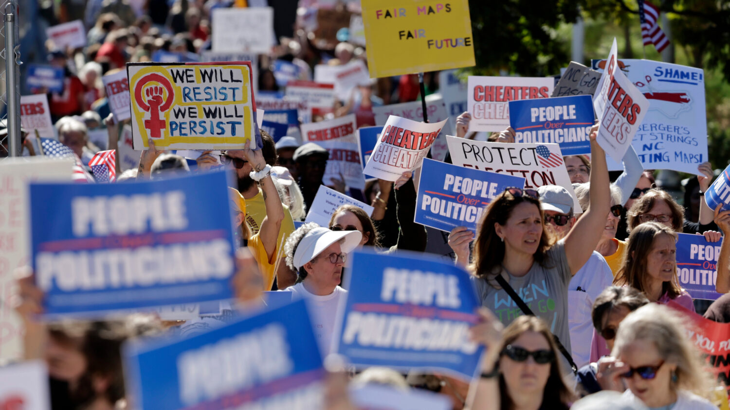 Marchers proceed from the Capitol during a rally protesting a proposed election redistricting map T...