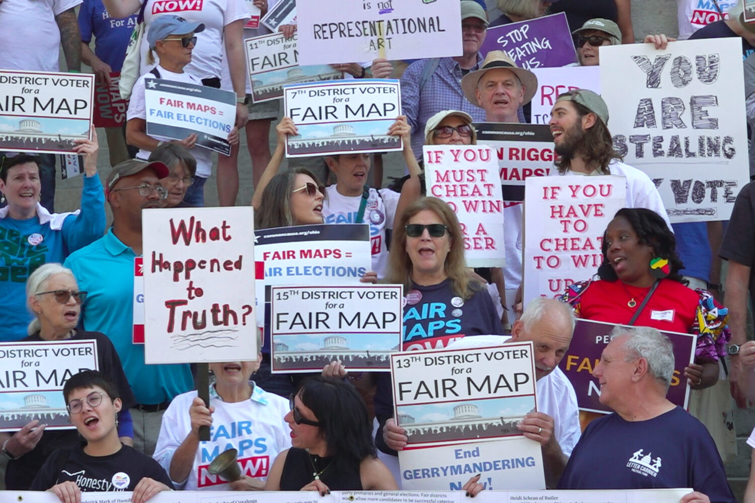 This photo taken from video shows organizers rallying outside of the Ohio Statehouse to protest ger...