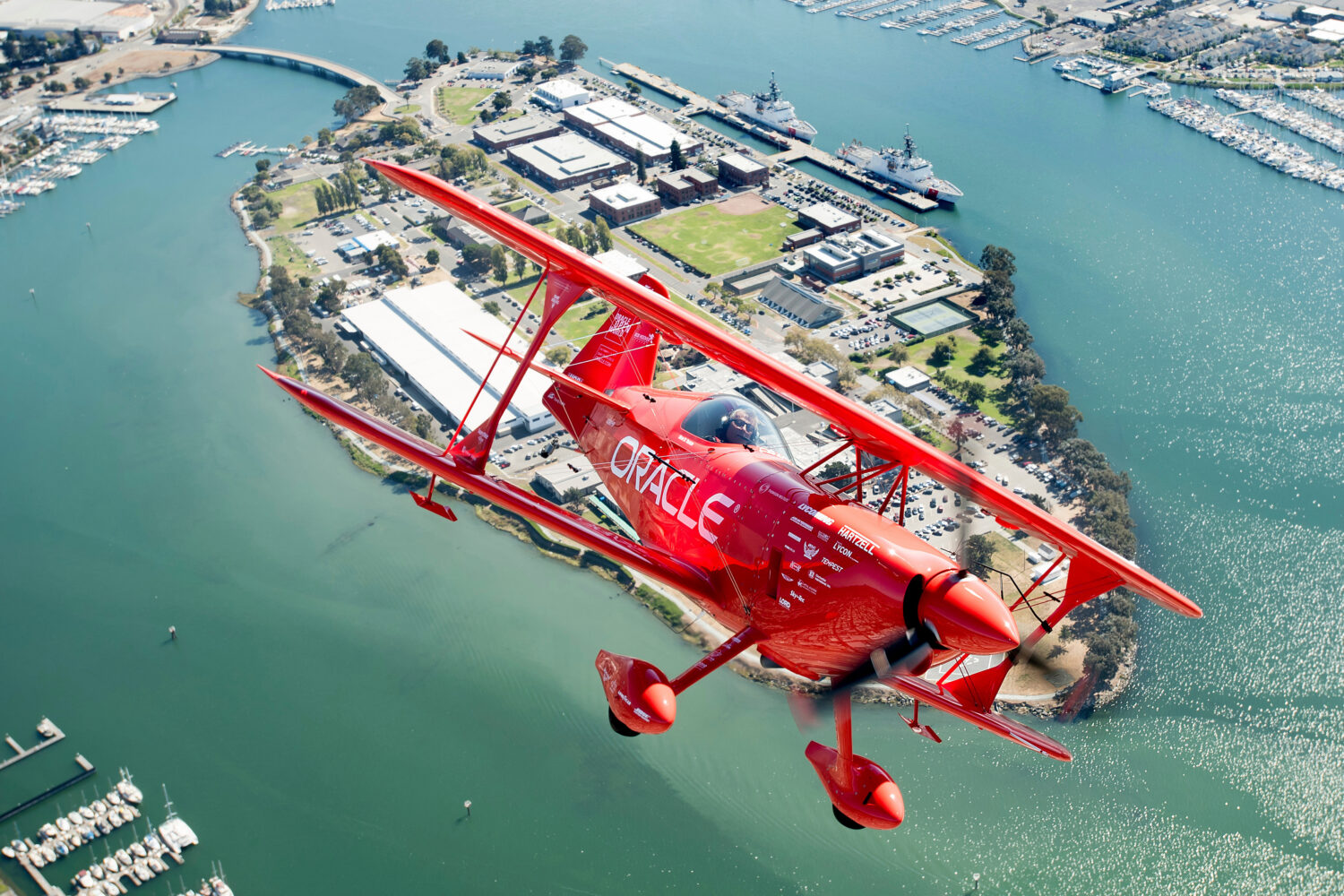 FILE - Team Oracle aerobatics pilot Sean D. Tucker flies over Coast Guard Island during a photo fli...