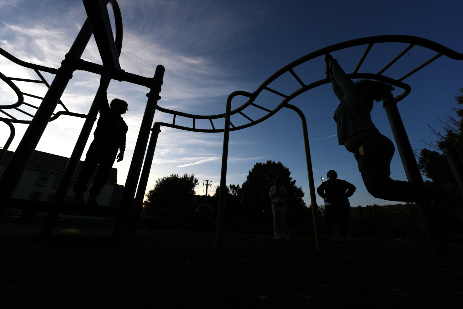 Children play on the monkey bars outside Funston Elementary School as night falls, in Chicago's Log...