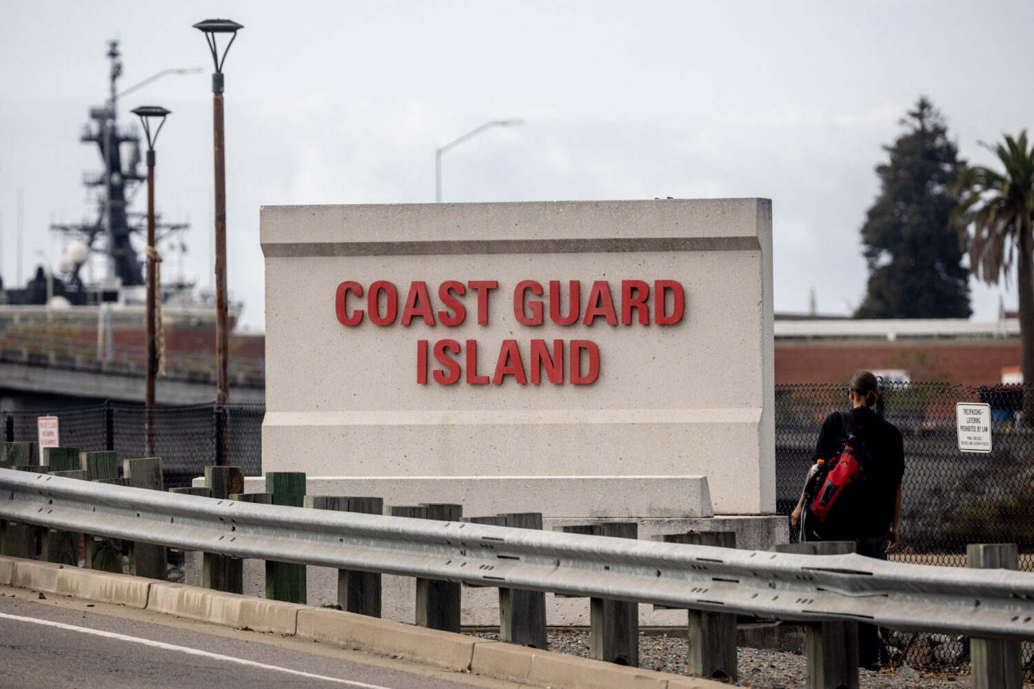 A sign stands by the bridge that leads to Coast Guard Island Alameda in Oakland, Calif., Wednesday,...