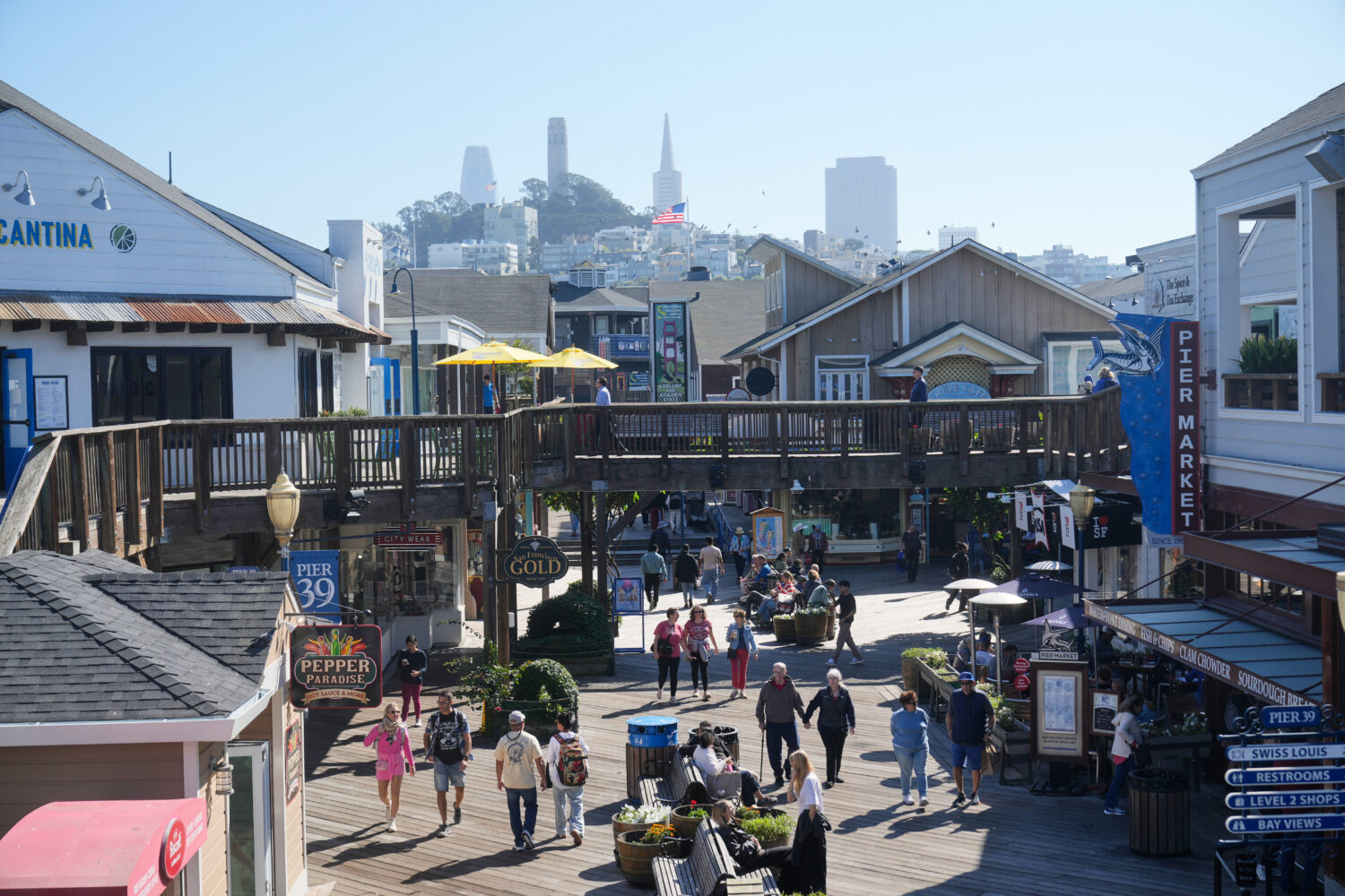 Visitors walk on the boardwalk at Fisherman's Wharf on Tuesday, Oct. 21, 2025, in San Francisco. (A...