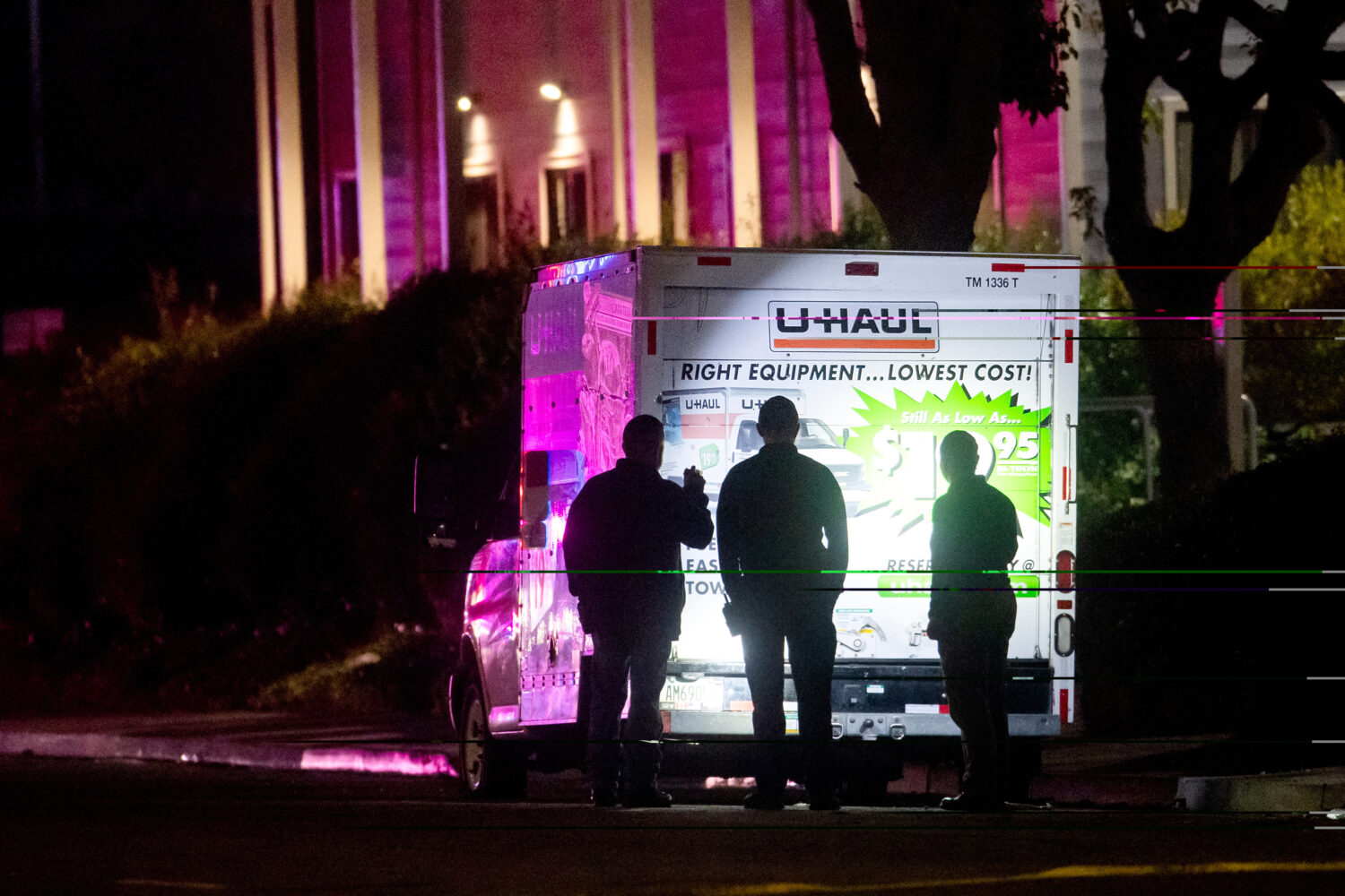 Police officers examine a U-Haul truck involved in a shooting at the entrance to Coast Guard Base A...
