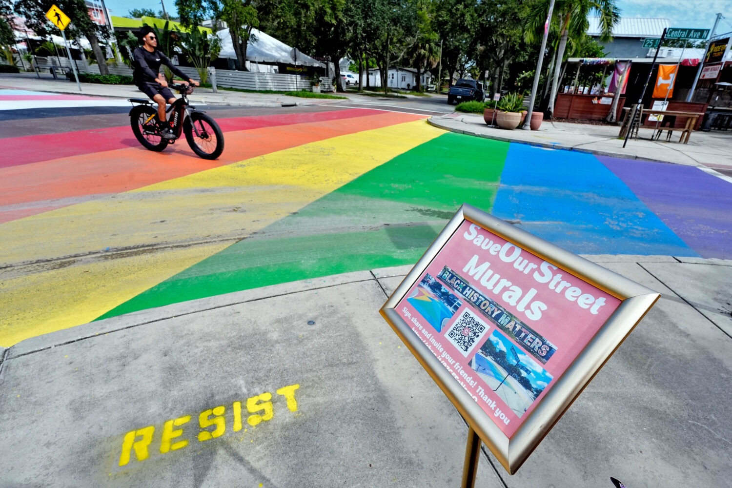 FILE - A cyclist crosses a rainbow-painted intersection, Aug. 27, 2025, in St. Petersburg, Fla. (AP...