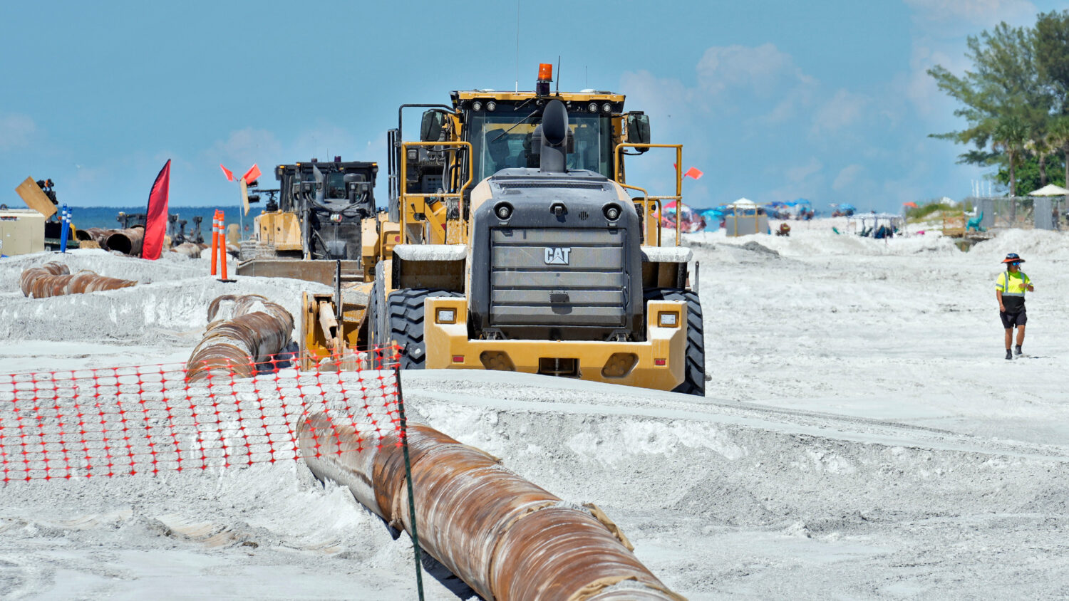 Workers replace the sand washed away by recent hurricanes along the gulf Thursday, Sept. 25, 2025, ...
