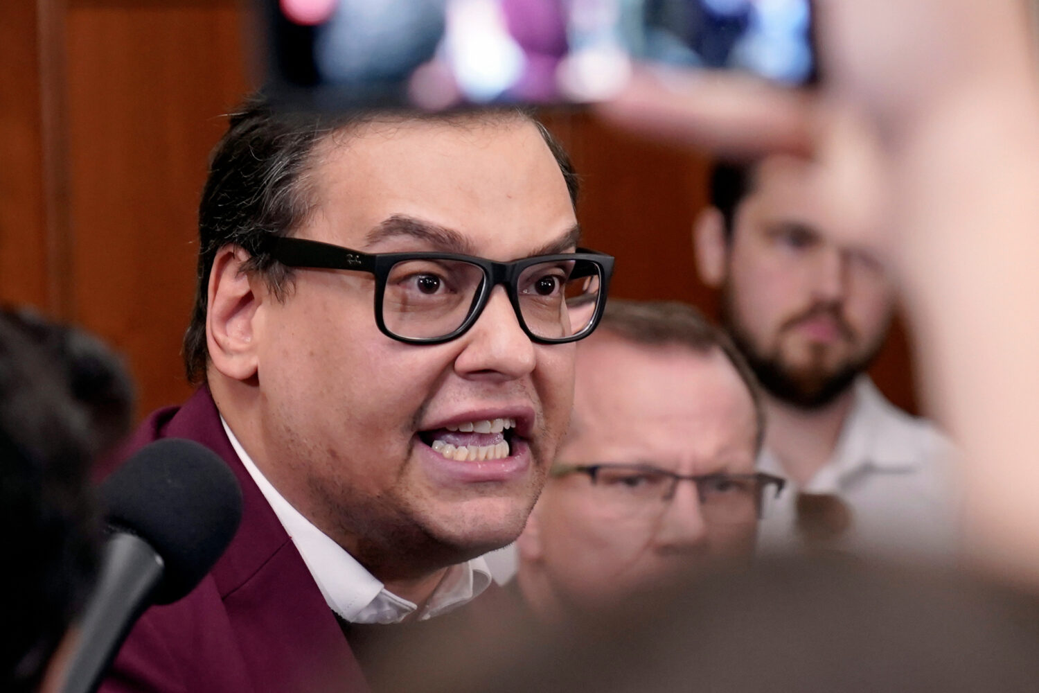 FILE - Rep. George Santos, R-N.Y., talks to reporters as House Republicans hold a caucus meeting at...