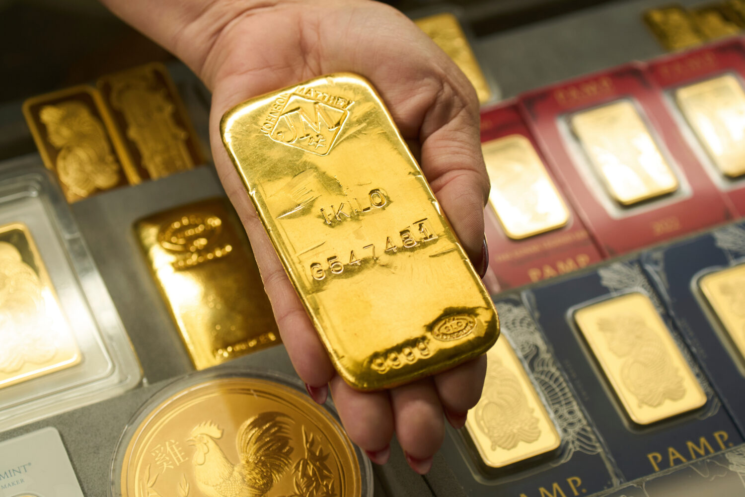 FILE - Sam Nguyen shows a gold bar at her shop in the St. Vincent Jewelry Center in the Jewelry Dis...