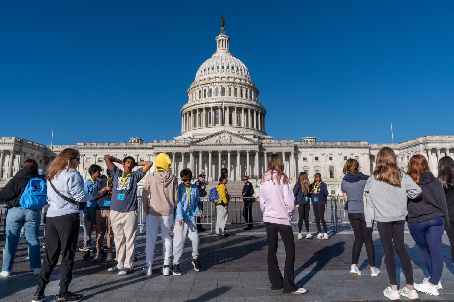 Students from Columbus, Ohio, wait outside a barrier as U.S. Capitol Police watch over the East Pla...
