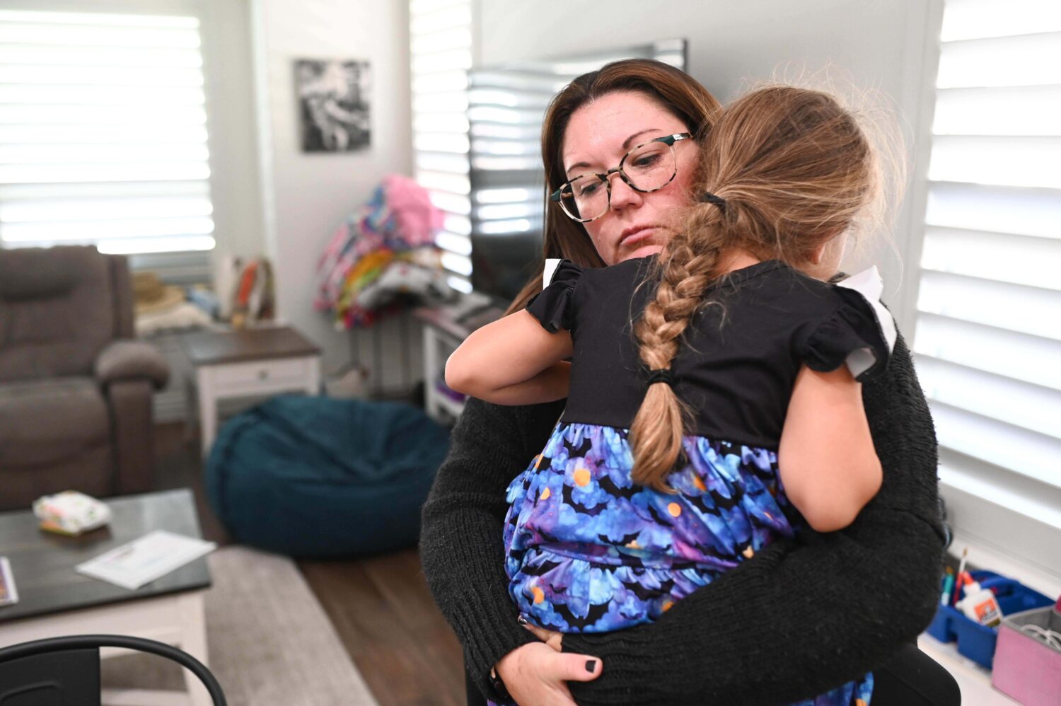 Jennifer Bittner holds her 6-year-old daughter Amelia at their home on Wednesday, Oct. 29, 2025, in...