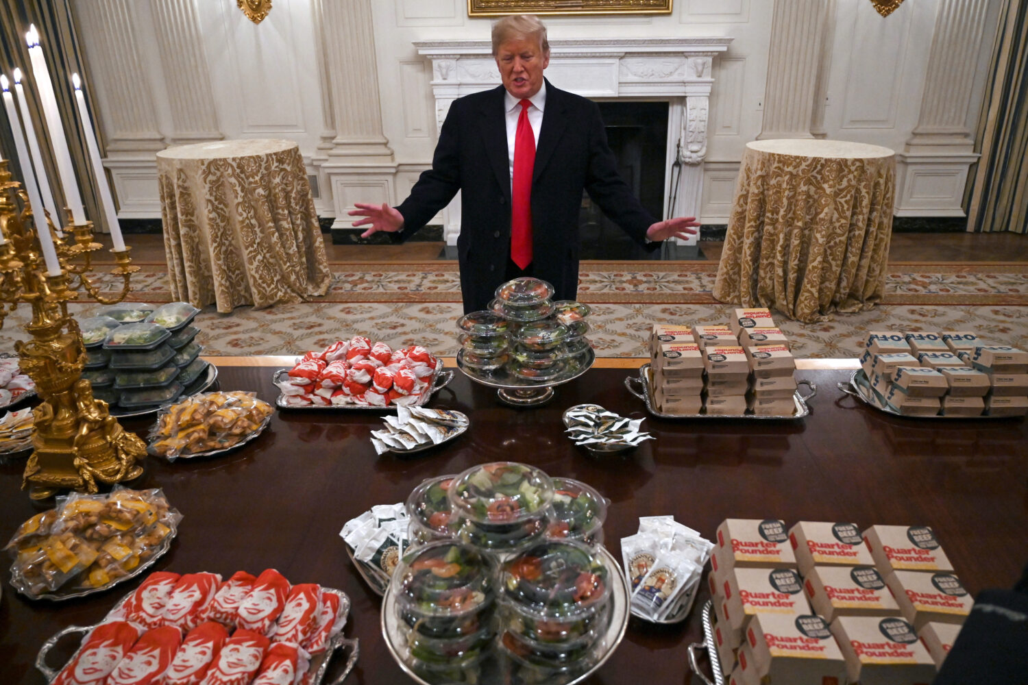 FILE - President Donald Trump talks to reporters about the table full of fast food in the State Din...