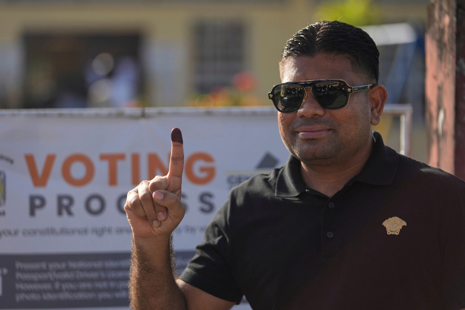 FILE - Presidential candidate Azruddin Mohamed of the We Invest in Nationhood party displays his in...