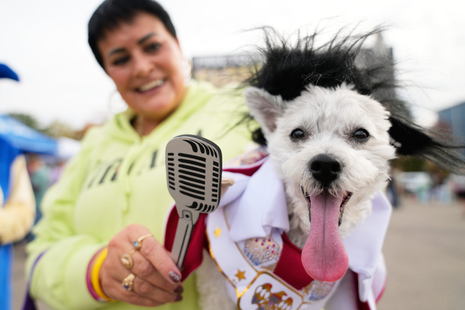 Michelle Dixon, of Laingsburg, holds her dog Abu, who is dressed as singer Elvis Presley, during an...