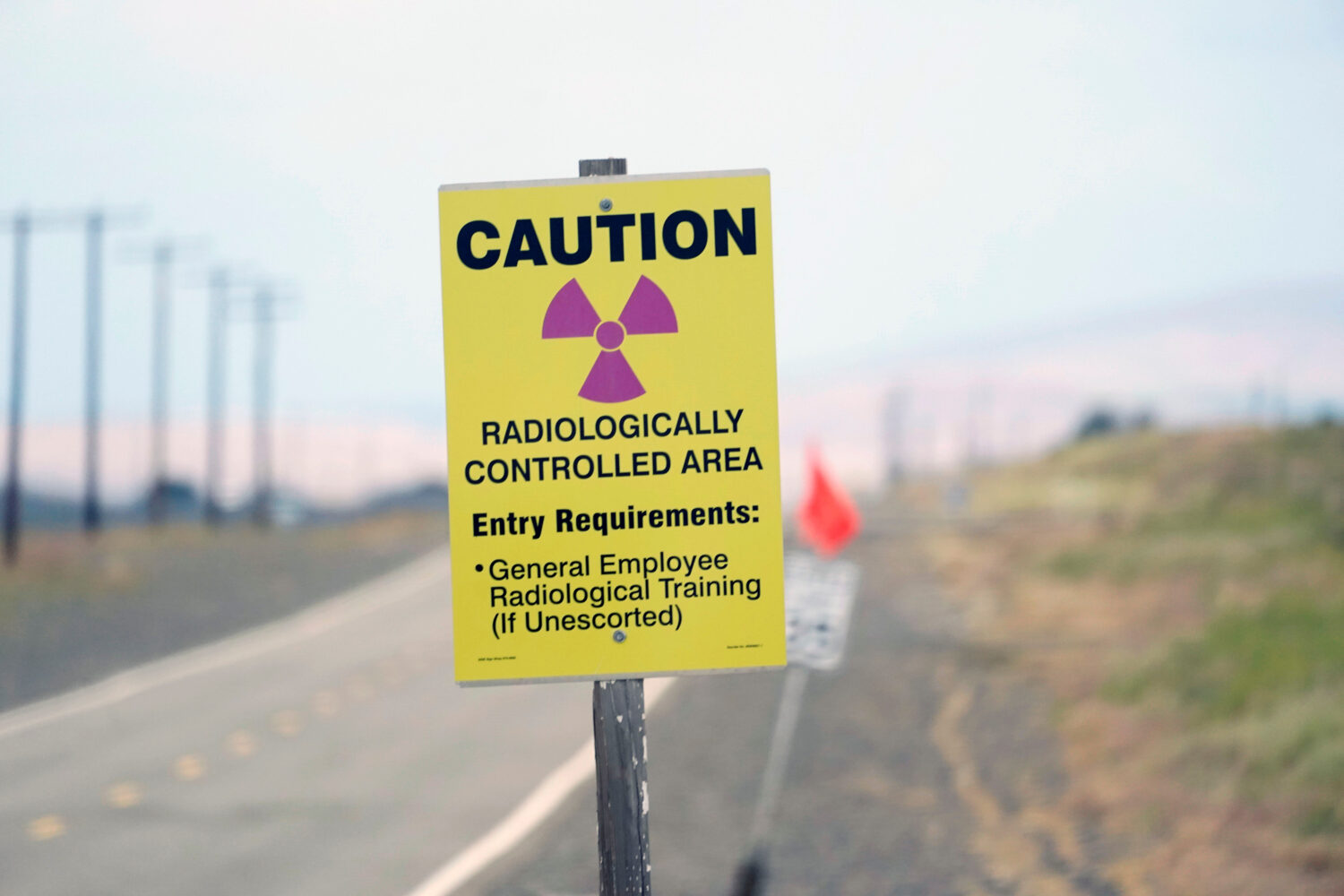 FILE - A caution sign is shown on a road on the Hanford Nuclear Reservation on June 2, 2022, in Ric...