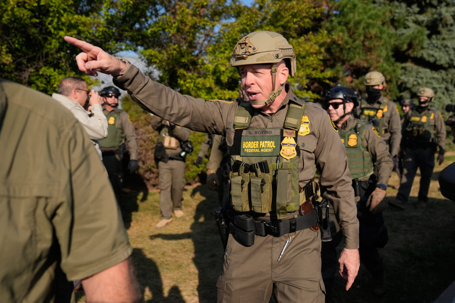 Greg Bovino, the chief patrol agent for the U.S. Border Patrol El Centro sector, center, walks with...