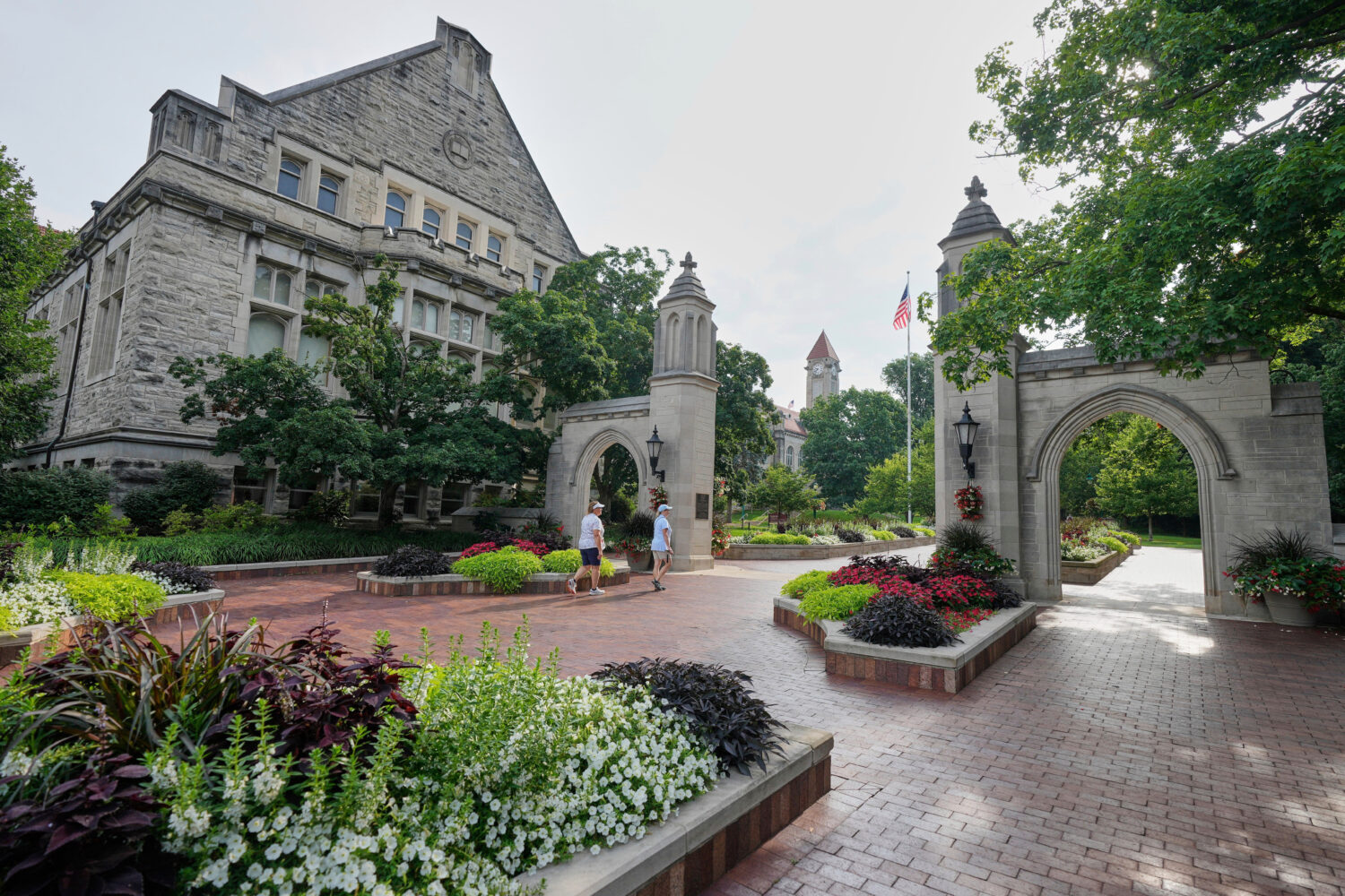 FILE - Guests walk on the campus of Indiana University, Thursday, July 17, 2025, in Bloomington, In...