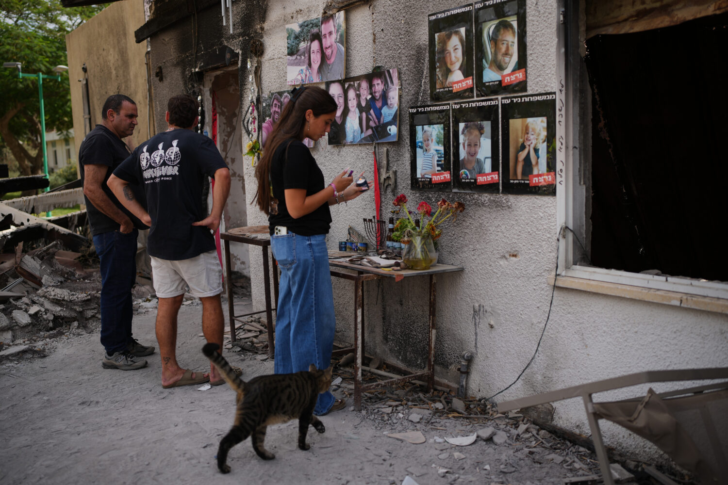 People visit the burnt house of Siman Tov family where all five family members were killed during t...