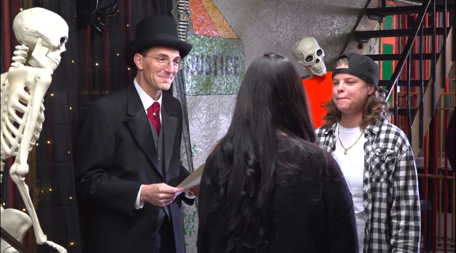 This photo taken from video shows Judge David Hejmanowski, back left, officiating the wedding of An...