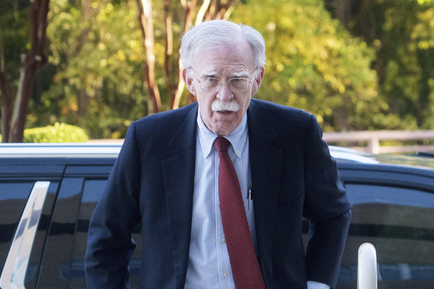 Former Trump administration national security adviser John Bolton, left, arrives for his arraignmen...