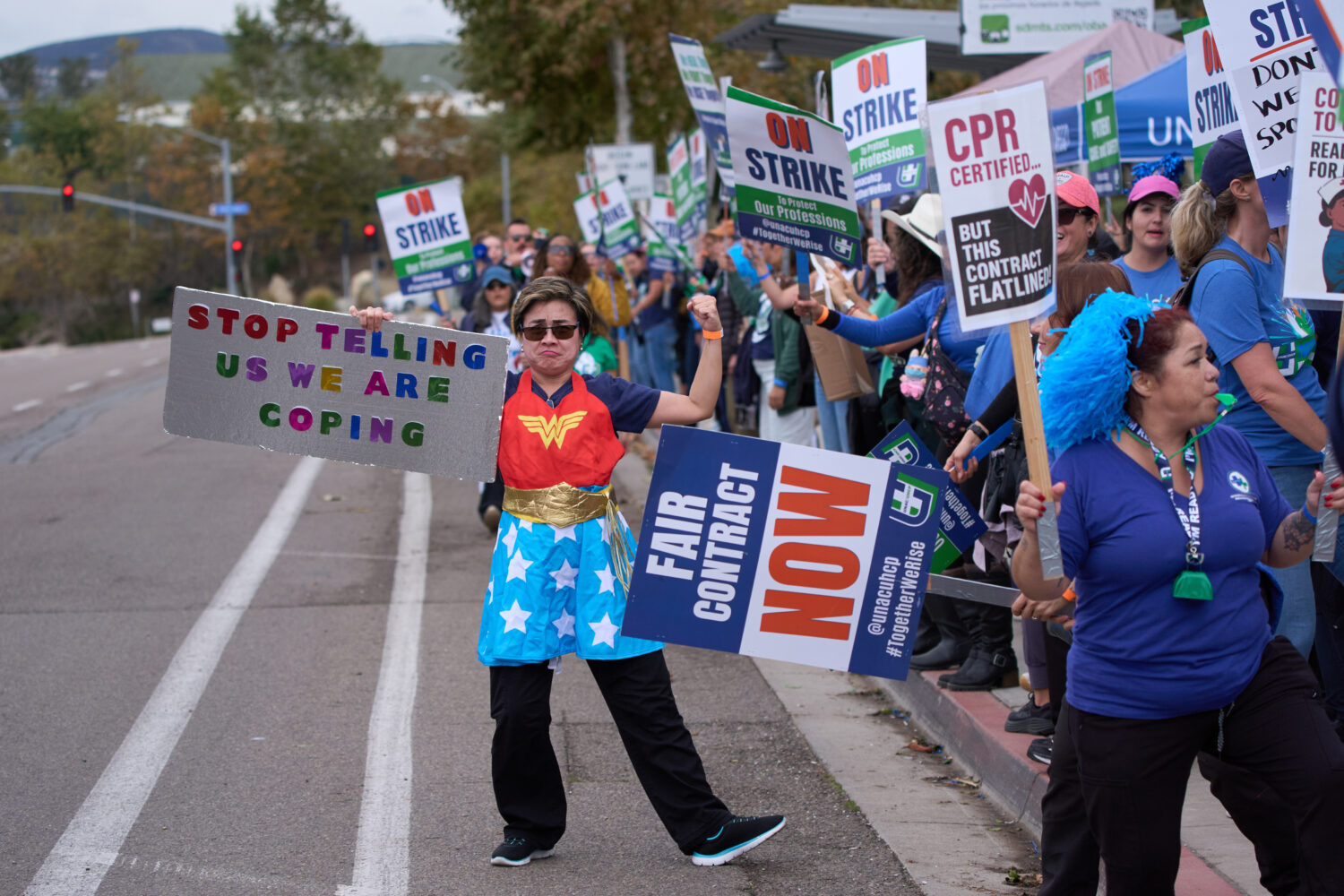 Kaiser Permanente health care workers hold signs and chant slogans while on strike in front of the ...