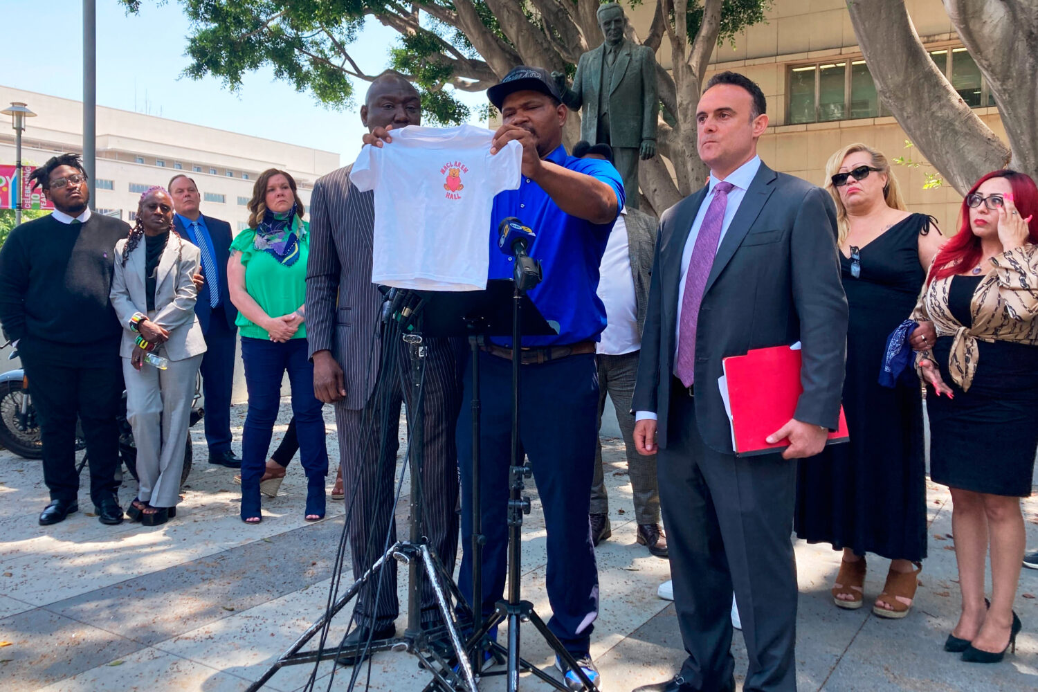 FILE - Jonathan Wright, 39, holds up the T-shirt he was given when he first went to MacLaren Childr...