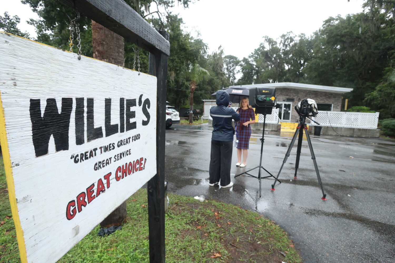 A reporter works outside of Willie's Bar and Grill in St Helena Island, S.C. after a shooting occur...