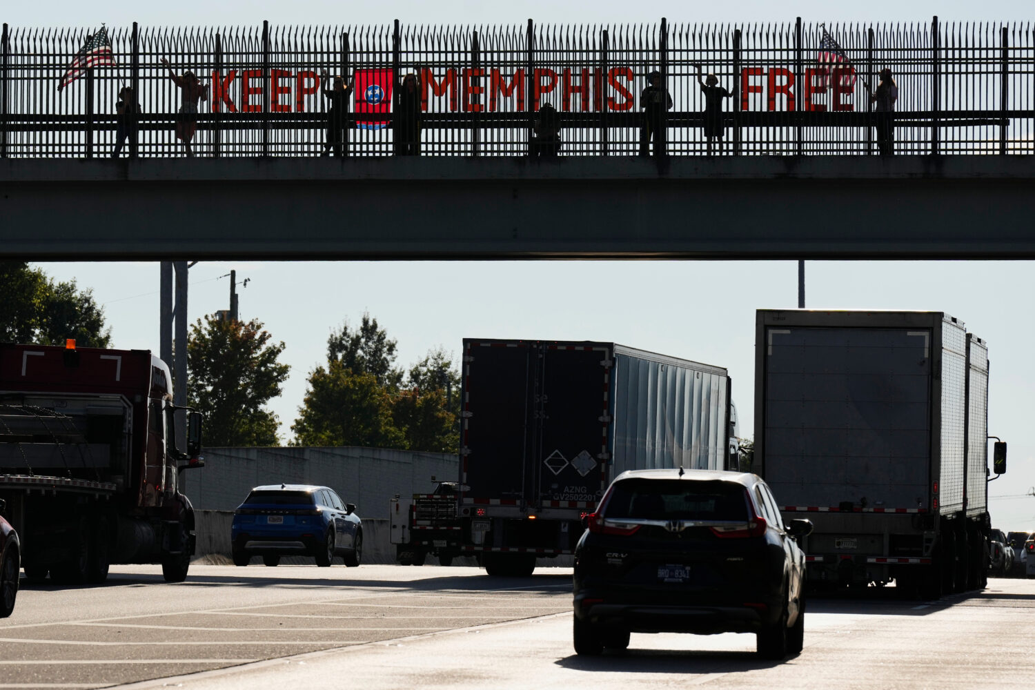 People demonstrate above Interstate 40 in Nashville, Tenn., Friday, Sept. 26, 2025, against the dep...