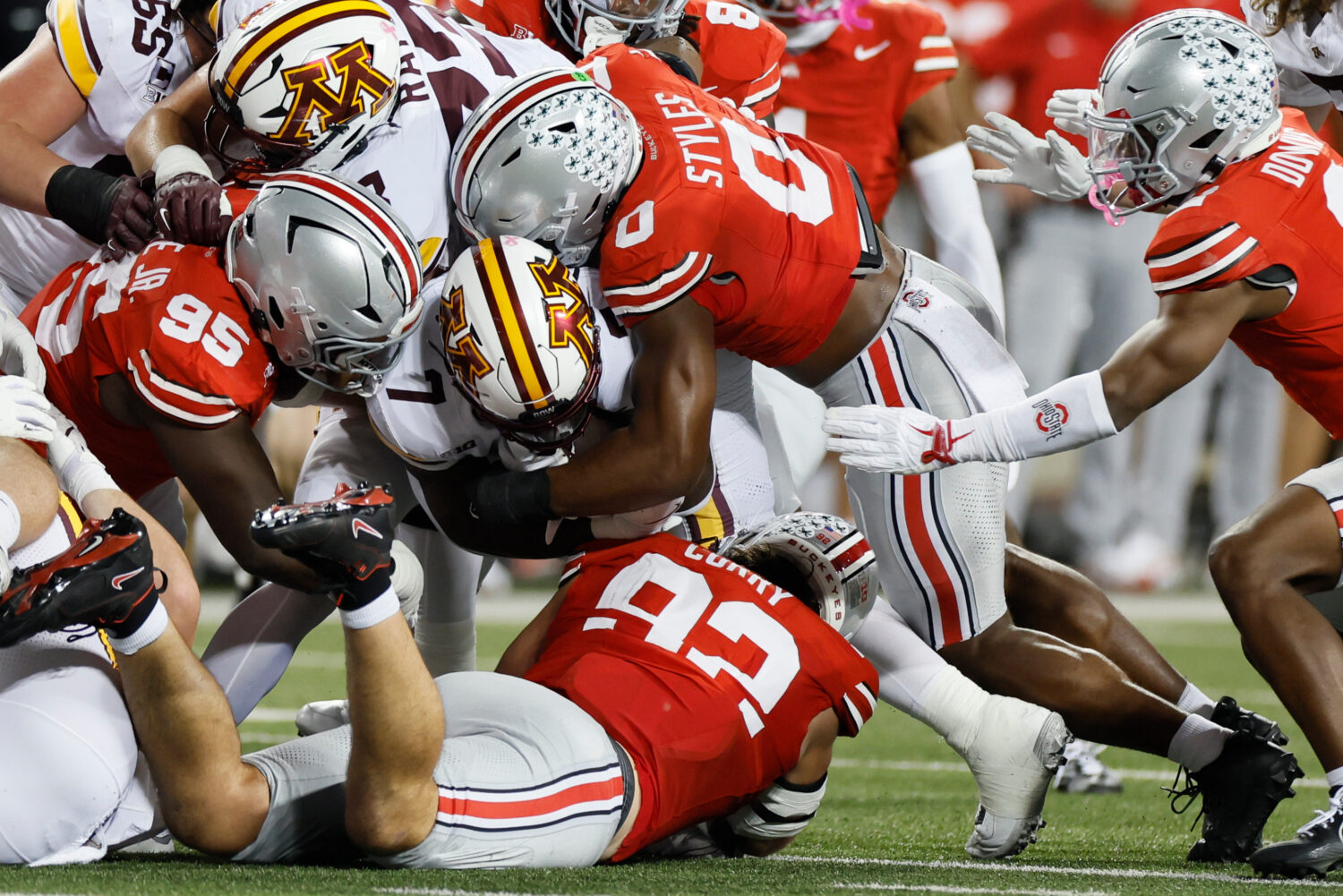 Ohio State defense swarms Minnesota running back Fame Ijeboi during the first half of an NCAA colle...