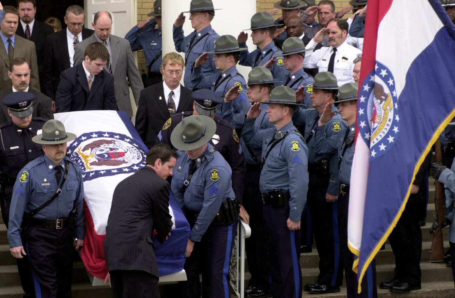 FILE - Members of the Missouri State Highway Patrol salute the body of fellow officer Sgt. Carl ''D...