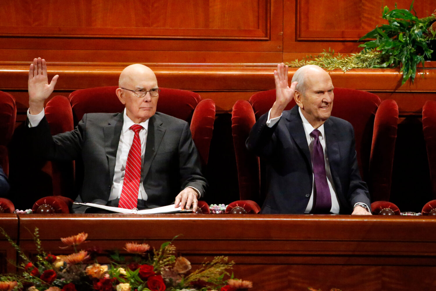 FILE - President Russell M. Nelson, right, raises his hand during a sustaining vote with his counse...