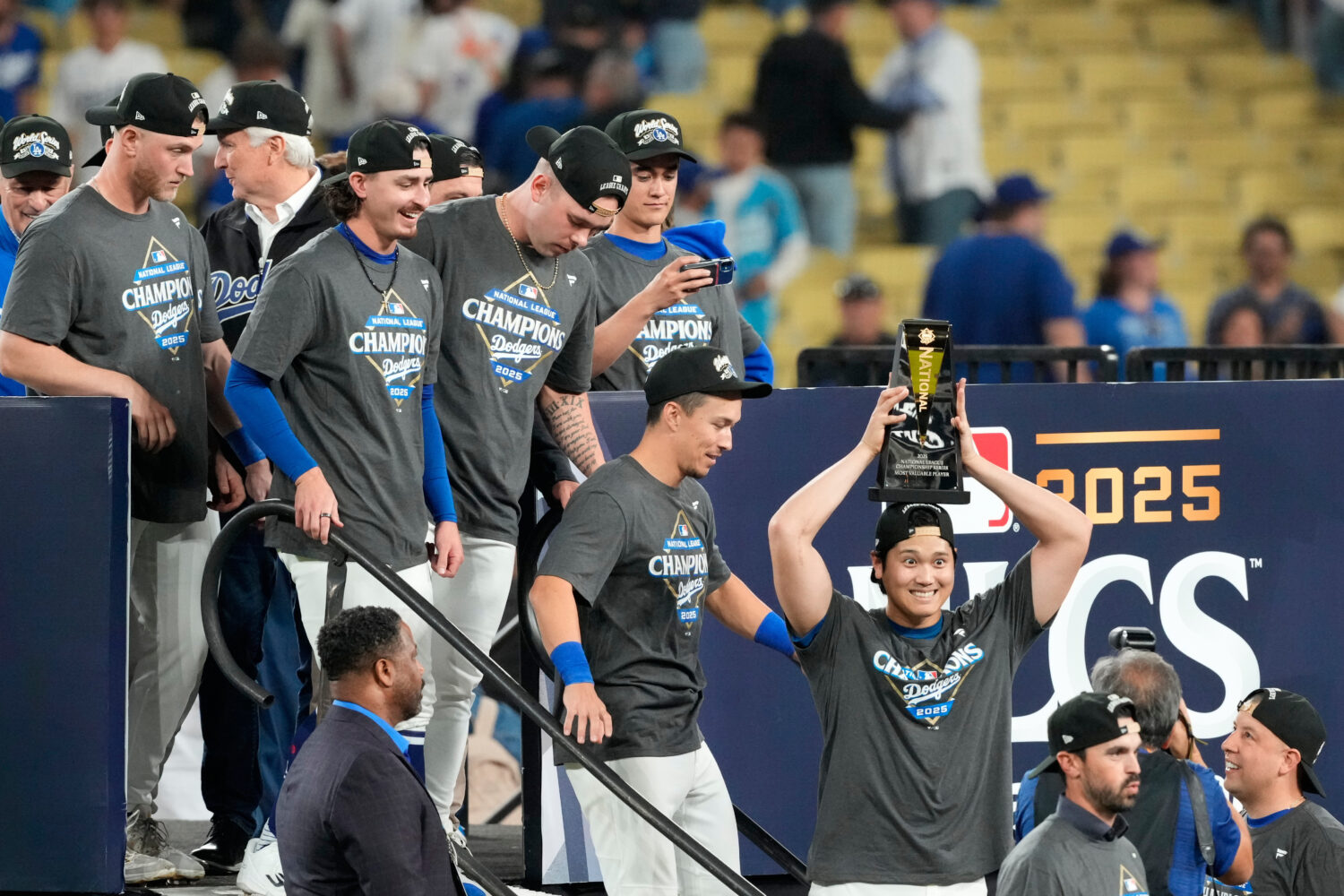 Los Angeles Dodgers' Shohei Ohtani celebrates the the trophy after their win against the Milwaukee ...